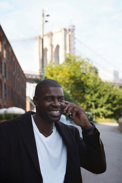 Young man outdoors exploring the city and using smartphone