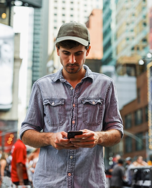 Photo young man outdoors using phone