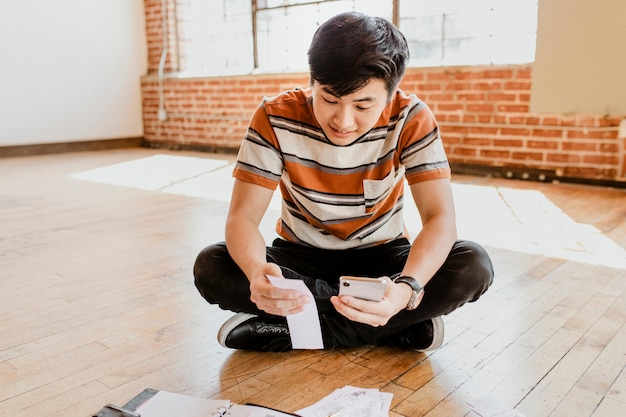 Young man paying bills online via internet banking