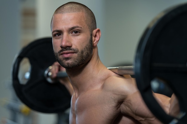 Young Man Performing Barbell Squats One Of The Best Bodybuilding Exercise For Legs