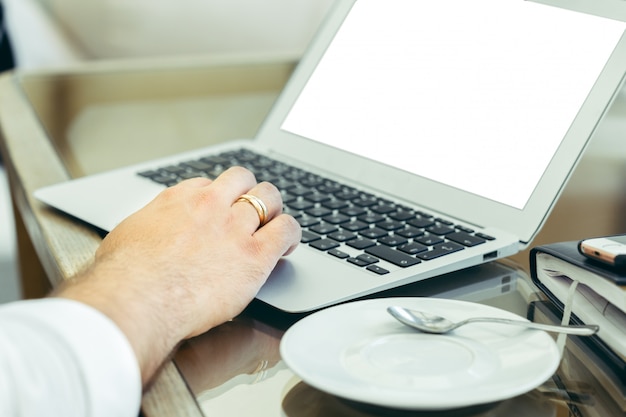 Young man performs work on a laptop