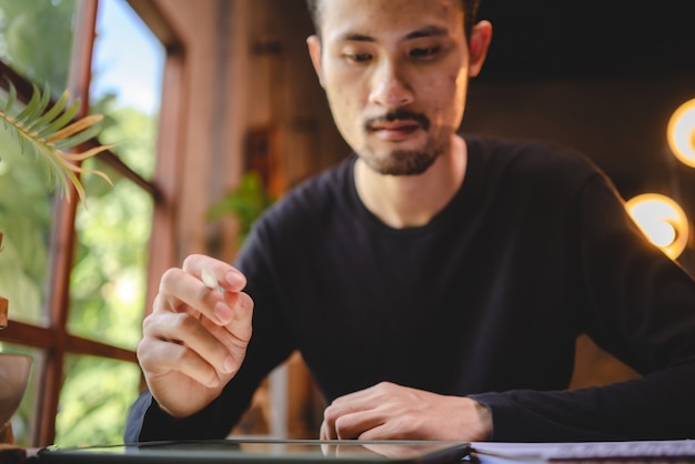 Young man person using computer laptop or tablet for work and learning online communication from home, cyberspace education technology for business people or student using to work, hipster businessman