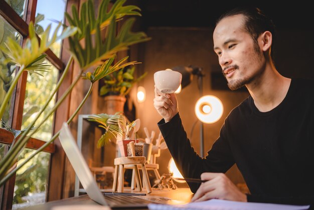 Young man person using computer laptop or tablet for work and learning online communication from home, cyberspace education technology for business people or student using to work, hipster businessman