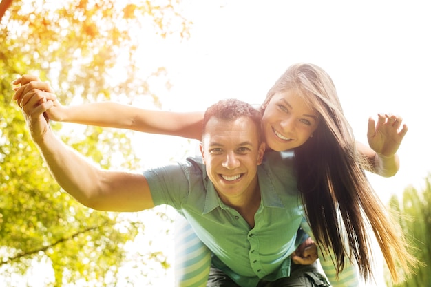 Young man piggybacking his girlfriend