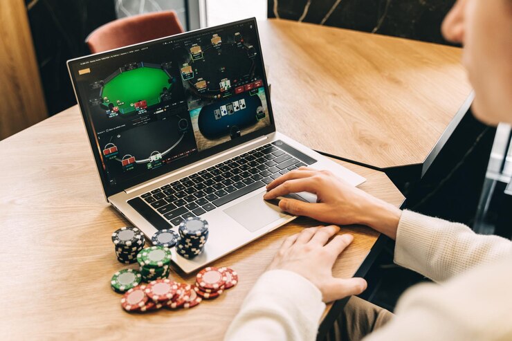 Young man play online poker in laptop