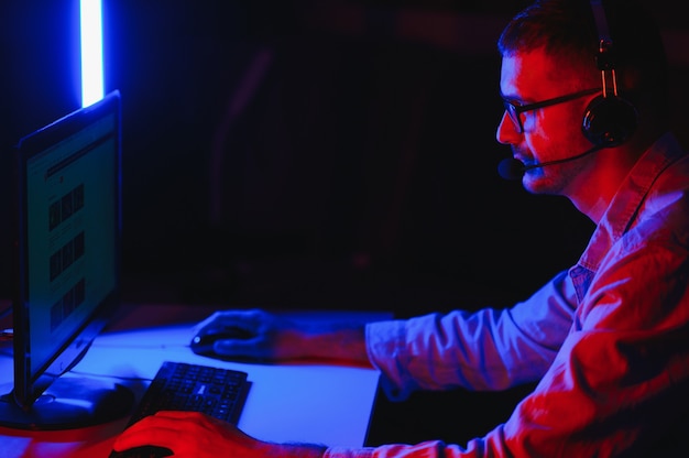 Young man playing computer games on line