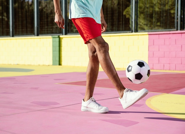 Foto giovane che gioca a calcio da vicino