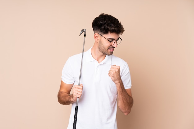 Young man playing golf and celebrating a victory