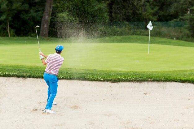 Young man playing golf