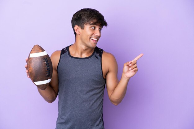 Young man playing rugby isolated on purple background intending to realizes the solution while lifting a finger up