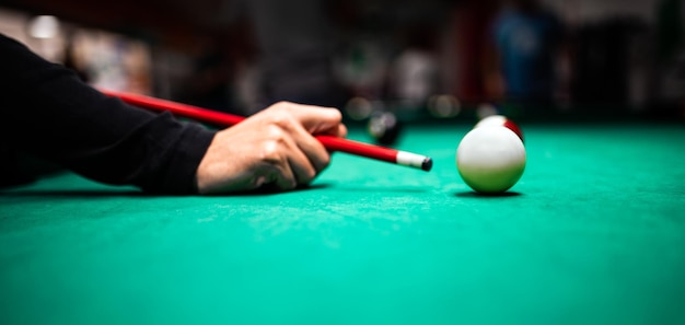 Photo young man playing snooker aiming for a good shot