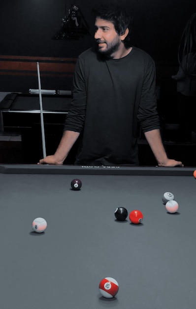 Young man playing with ball on table