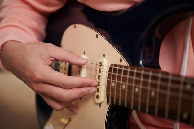 Young Man Plucking Guitar