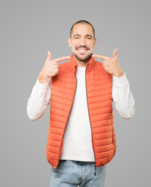 Young man pointing to his teeth