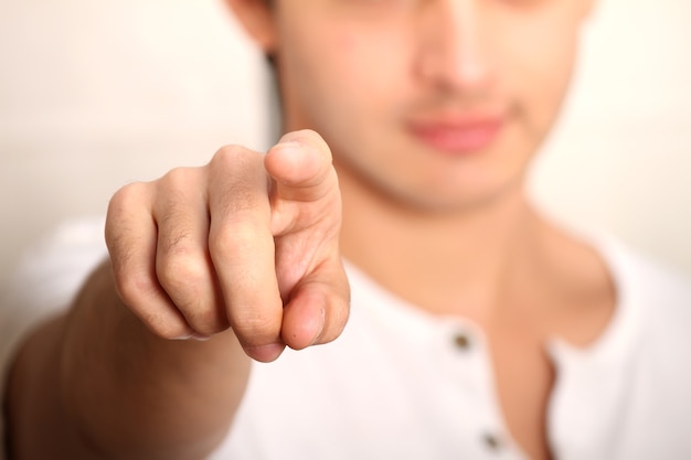 A young man pointing at you.