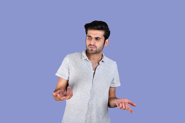 Young man posing infront wearing summer clothes feeling confused indian pakistani model