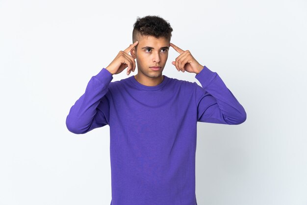 Young man posing isolated against the blank wall