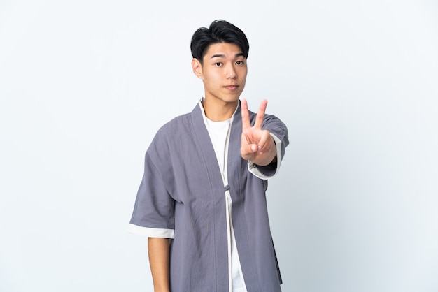 Young man posing isolated against the blank wall