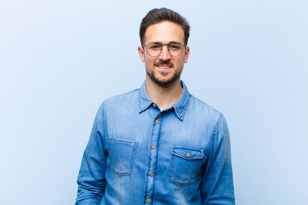 a young man posing while smiling cheerfully and casually