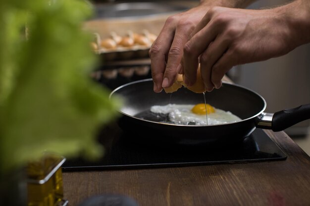 young man preparing eggs