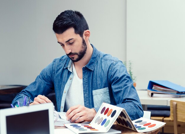 Young man preparing a new decoration project in a coworking espace