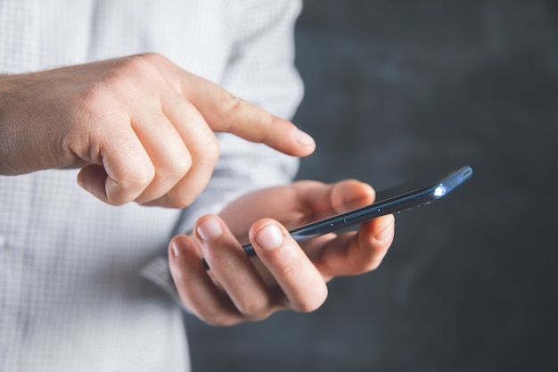 Young man pressing a phone sensor .