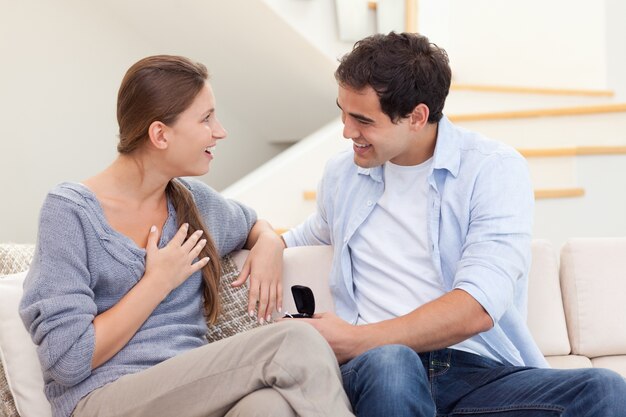 Young man proposing marriage to his girlfriend