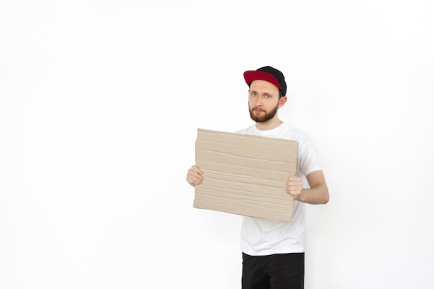 Young man protesting with blank board