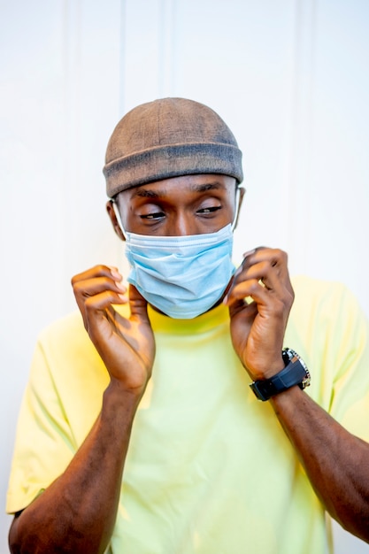 Young man putting on a surgical mask