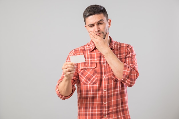 Young man reading business card