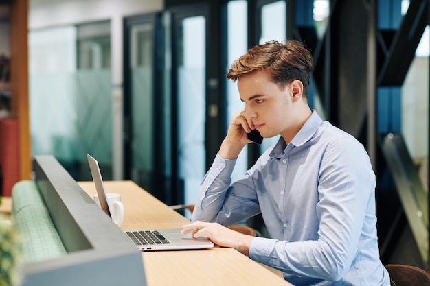 Young man reading document online