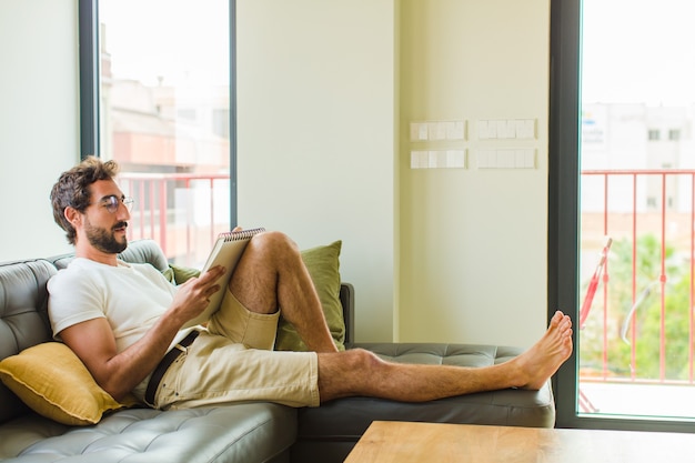 Young man reading at home