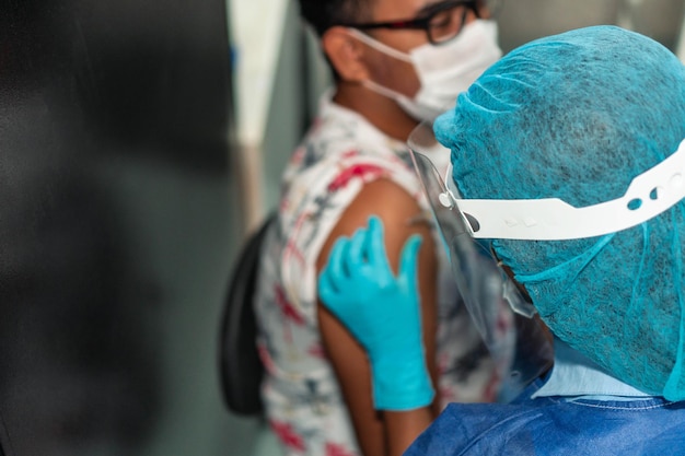 Young man receiving coronavirus vaccine