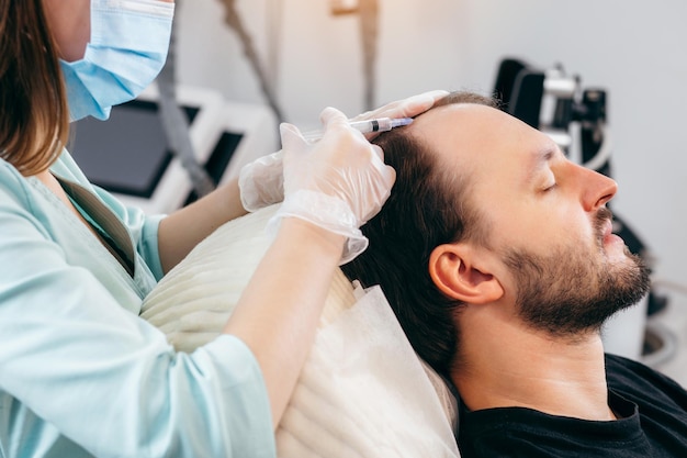 Young man receiving injection, close up