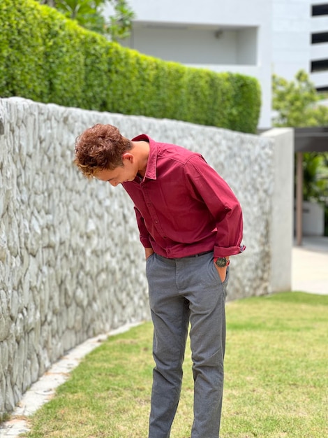 young man in red shirt and trousers