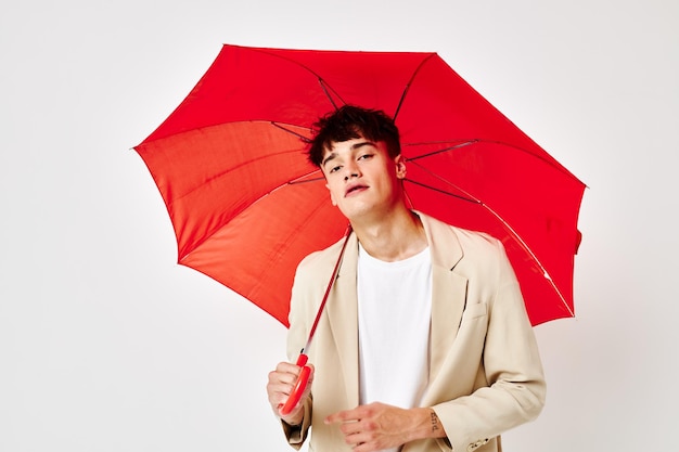 A young man red umbrella a man in a light jacket isolated\
background unaltered