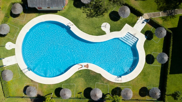 young man relaxing at swimming pool	

