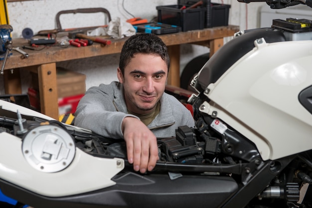 Young man repairing the motorcycle