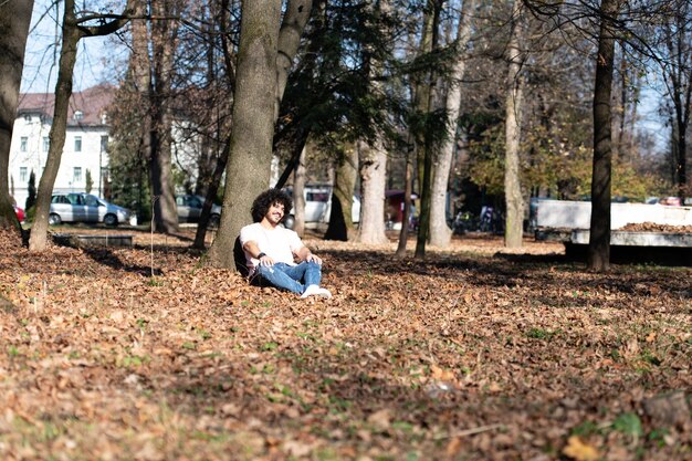 Young Man Resting in Autumn Forest