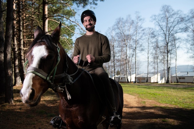 Young Man Rides a Horse Wearing a Helmet