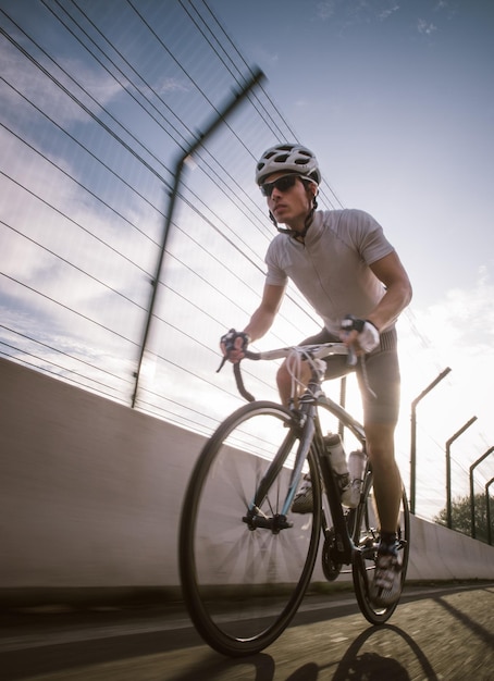 Young man riding bicycle on road