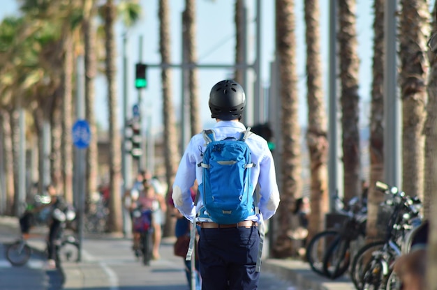 Young man riding a scooter down the street