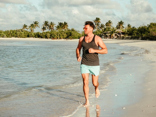 Young man running along the coast of the Atlantic Ocean