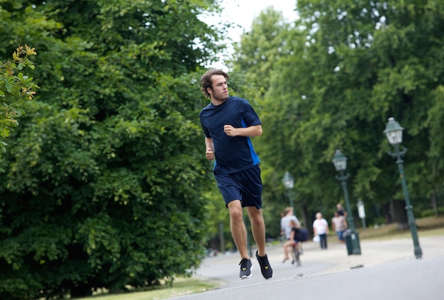 Young man running on footpath