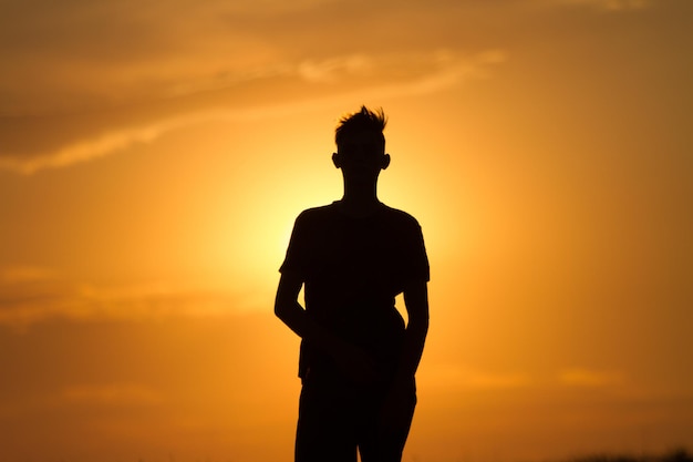 young man running and showing movement at sunset