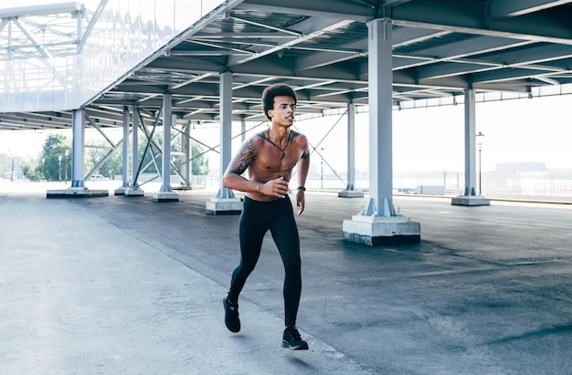 young man running on street in city