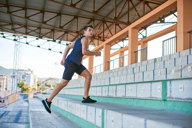 Young man running upstairs on stadium