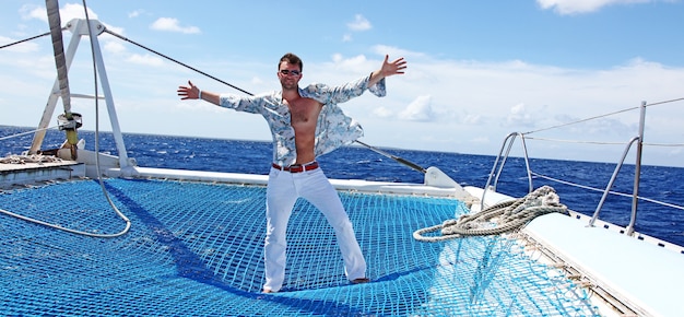 Young man sailing his boat on the open ocean