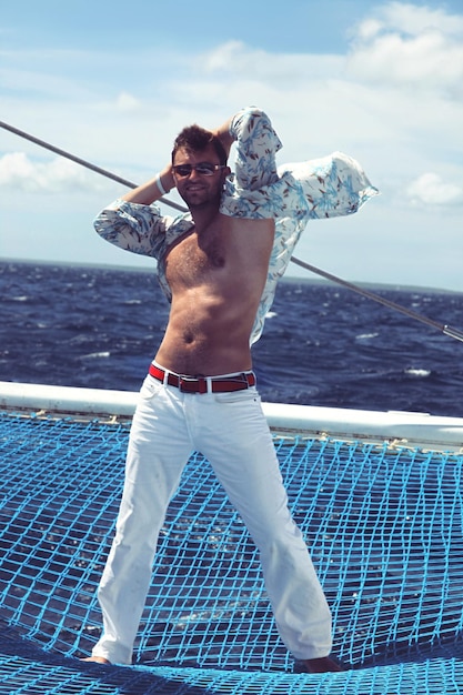 Young man sailing his boat on the open ocean