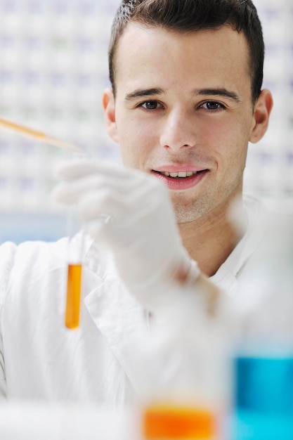 young man scientist in chemistry bright lab